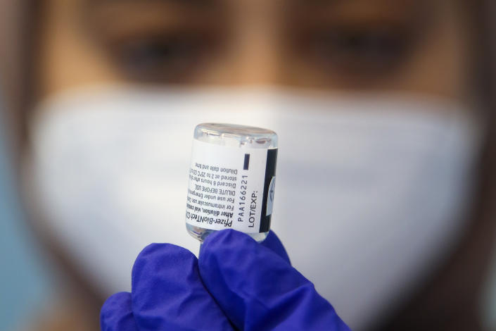 A National Health Service (NHS) staff holds a vial containing Pfizer Covid-19 vaccine at a vaccination centre in London. (Photo by Dinendra Haria / SOPA Images/Sipa USA)
