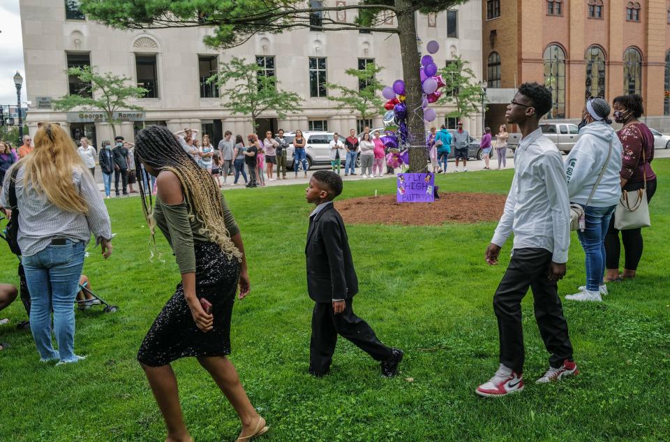 People begin to gather Saturday, July 8, 2023, at the memorial site on the Capitol lawn for Wynter Cole-Smith, the 2-year-old girl who was declared missing and later found dead in Detroit earlier in the week.