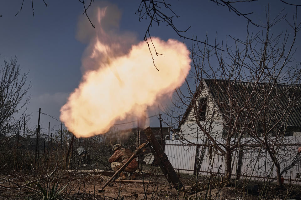 FILE - Ukrainian soldiers fire a mortar at Russian positions on the frontline near Bakhmut, Donetsk region, Ukraine, Sunday, March 26, 2023. Europe’s biggest armed conflict since World War II is poised to enter a key new phase in the coming weeks. With no suggestion of a negotiated end to the 13 months of fighting between Russia and Ukraine, a counteroffensive by Kyiv’s troops is in the cards. (AP Photo/Libkos, File)