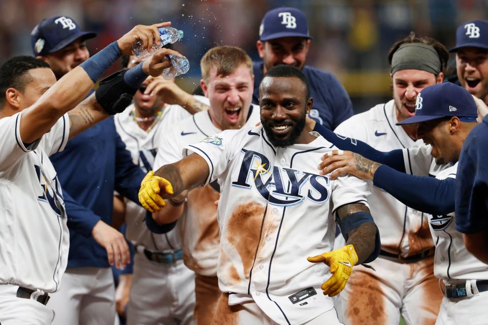 Tampa Bay Rays' Randy Arozarena, center front, celebrates with teammates after hitting a winning RBI single against the Cleveland Guardians during the ninth inning of a baseball game Saturday, Aug. 12, 2023, in St. Petersburg, Fla. (AP Photo/Scott Audette)