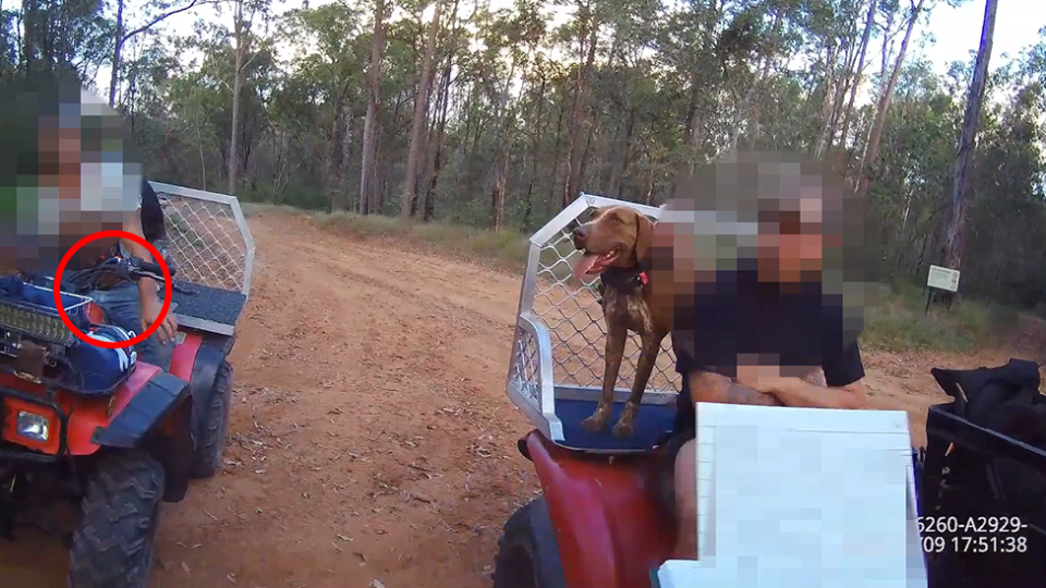 Two men on quad bikes inside the Lockyer National Park. One has his dog on the back of the bike. There is a red circle around the knife on the guy's waste.