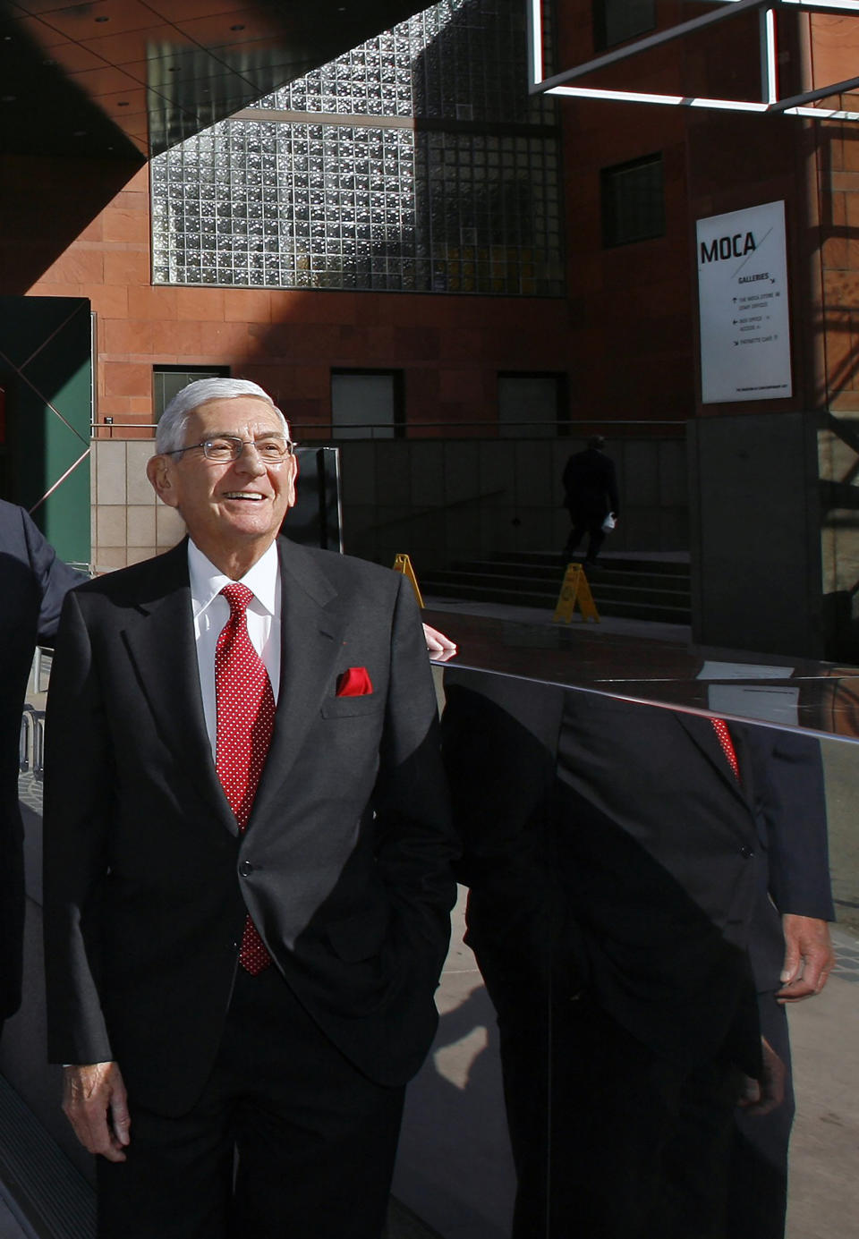 FILE - In this Dec. 23, 2008 file photo, billionaire Eli Broad poses for a picture outside the MOCA museum downtown Los Angeles. Eli Broad, the billionaire philanthropist, contemporary art collector and entrepreneur who co-founded homebuilding pioneer Kaufman and Broad Inc. and launched financial services giant SunAmerica Inc., died Friday, April 30, 2021 in Los Angeles. He was 87. (AP Photo/Damian Dovarganes, File)