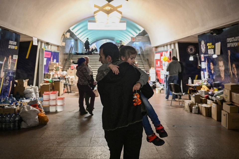 People living in a metro station used as a bomb shelter walk in a corridor in Kharkiv on March 26, 2022, during Russia's military invasion launched on Ukraine.