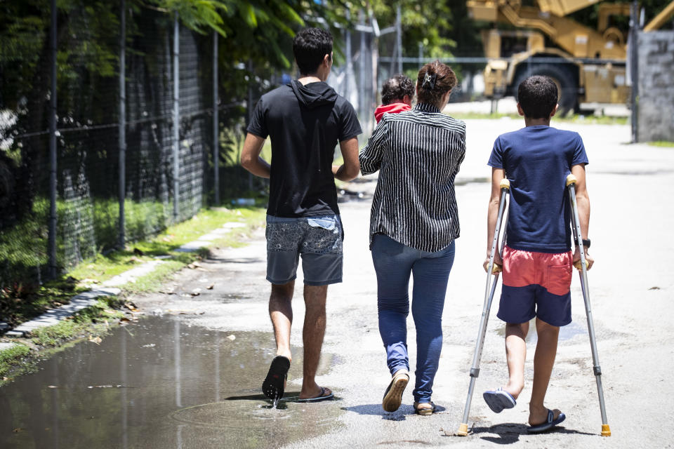 In this Sept. 4, 2018, photo, from left, Mohammad, 17, Aryana, two and a  half months old, his mother and little brother Amirparsa, 11, are pictured on Nauru. 