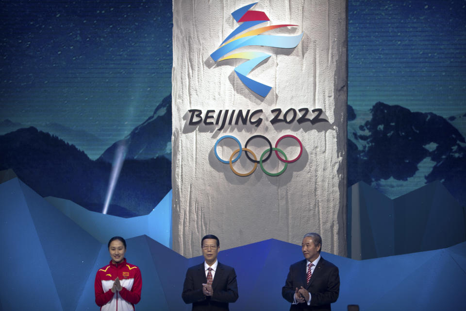 FILE - From left, 2014 Olympic speed skating gold medalist Zhang Hong of China, then Chinese Vice Premier Zhang Gaoli, and Vice Chairman of the Chinese Olympic Committee Yu Zaiqing applaud as the emblem for the 2022 Beijing Winter Olympic Games is unveiled at a ceremony at the National Aquatics Center, also known as the Water Cube, in Beijing, Friday, Dec. 15, 2017. Chinese authorities have squelched virtually all online discussion of sexual assault accusations apparently made by a Chinese professional tennis star against the former top government official, showing how sensitive the ruling Communist Party is to such charges. (AP Photo/Mark Schiefelbein, File)