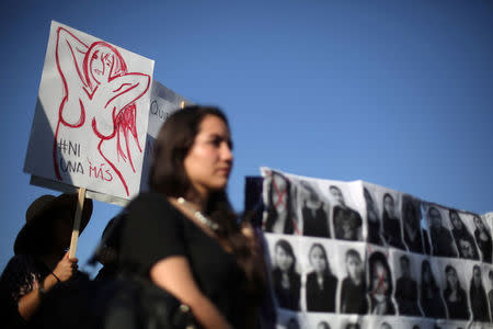 Activists take part in a march to protest violence against women and the murder of a 16-year-old girl in a coastal town of Argentina last week, at Revolucion monument, in Mexico City, Mexico, October 19, 2016. The sign reads, "Not one more". REUTERS/Edgard Garrido