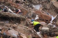 Rescue workers search for people in the rubble of a five-storey apartment building after it collapsed in Mahad. (Photo by PUNIT PARANJPE/AFP via Getty Images)