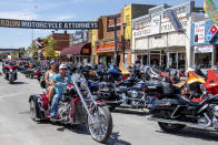FILE - In this Aug. 15, 2020 file photo, bikers ride down Main Street during the 80th annual Sturgis Motorcycle Rally in Sturgis, S.D. According to a Friday, Nov. 20, report from the Centers for Disease Control and Prevention the summer's huge motorcycle rally in South Dakota led to dozens of coronavirus cases in neighboring Minnesota. (Amy Harris/Invision/AP)