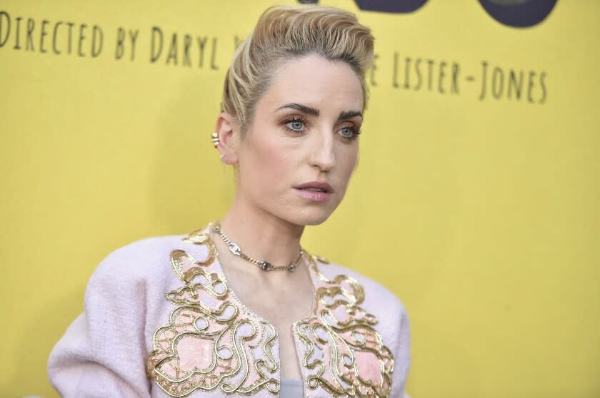 A woman poses at a red-carpet event