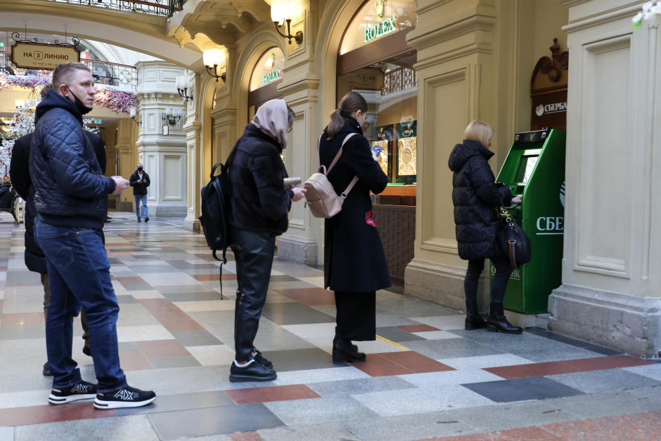 People queue by a Sberbank ATM machine in Moscow on Monday.