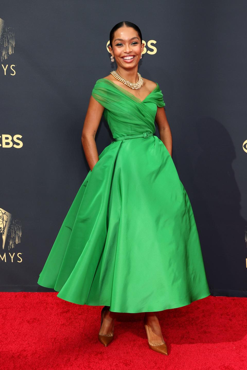 Yara Shahidi wears a green dress at the Emmys.