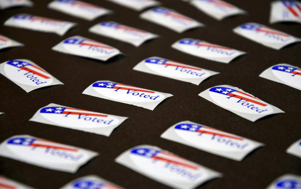 FILE - "I Voted" stickers are displayed at a polling place in Cheyenne, Wyo., Aug. 16, 2022. Switching political parties to be able to choose which primary to vote in is an old Wyoming tradition, one facing growing criticism as the state's Democrats struggle to field strong candidates and Republican primaries often all but decide who eventually wins office. (AP Photo/Thomas Peipert, File)