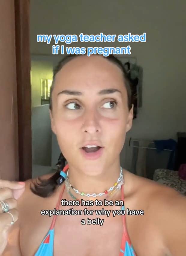 A yoga teacher asks a woman if she is pregnant