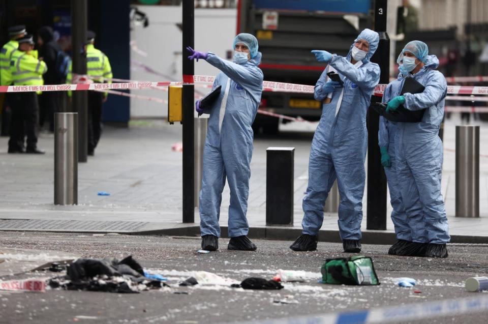 Forensic officers work at the scene where two policemen were stabbed, near Leicester Square, in London (REUTERS)