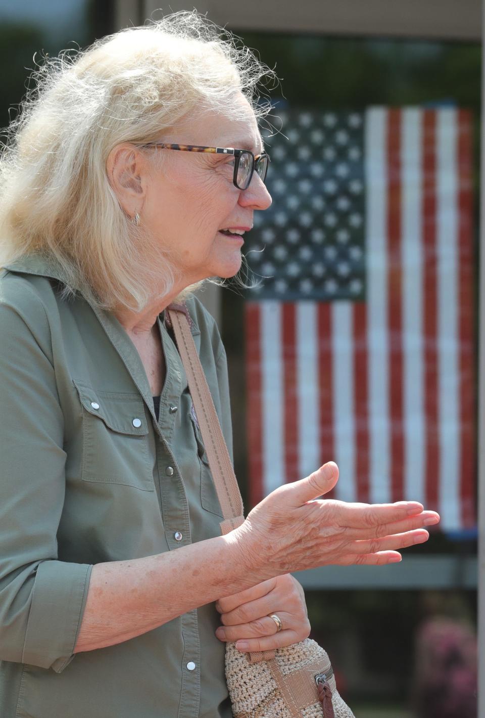 Jeri Knight of Green talks outside Queen of Heaven Catholic Church on Tuesday, August 8, 2023 in Green.