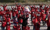 Participants shout slogans during a campaign to express their support to the global community efforts to overcome the coronavirus in Seoul, South Korea, Saturday, Oct. 24, 2020. (AP Photo/Lee Jin-man)