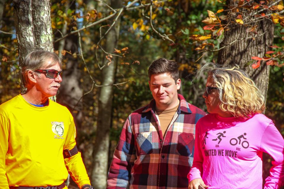 Visitors to the Southeastern Massachusetts Bioreserve, including James Hartman, center, await the opening of a new 20-mile trail on Wednesday, Oct. 19, 2022.