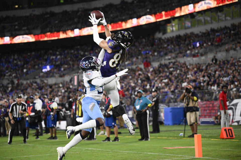 Baltimore Ravens wide receiver Shemar Bridges, right, catches a touchdown pass as Tennessee Titans cornerback Chris Jackson defends during the first half of a preseason NFL football game, Thursday, Aug. 11, 2022, in Baltimore. (AP Photo/Nick Wass)