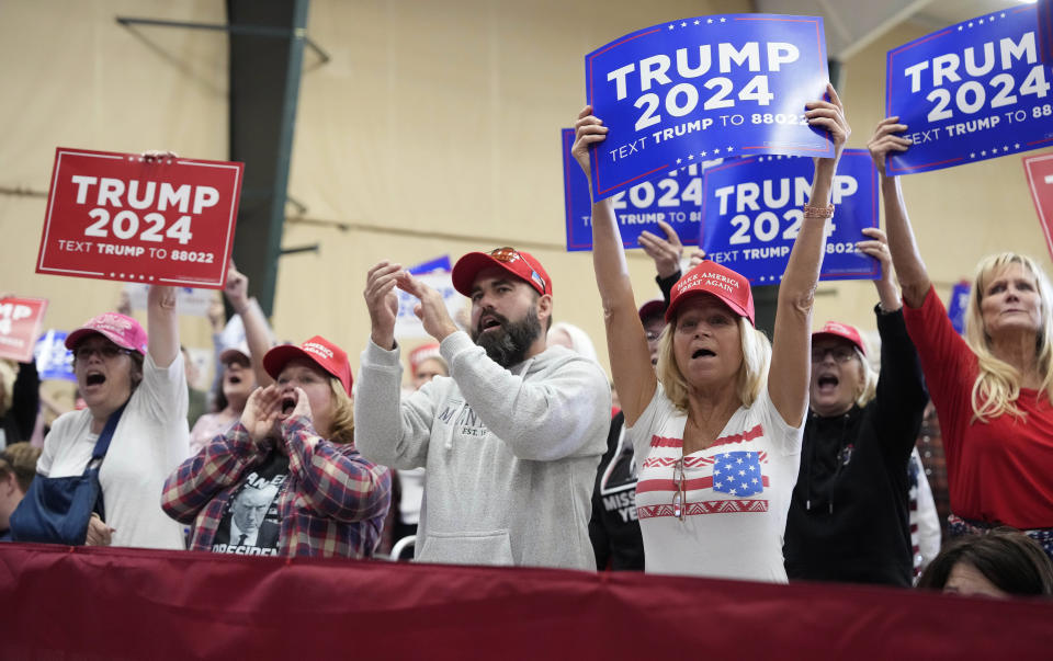 Audience members cheer for former President Donald Trump during a campaign rally Monday, Oct. 16, 2023, in Clive, Iowa. (AP Photo/Matthew Putney)