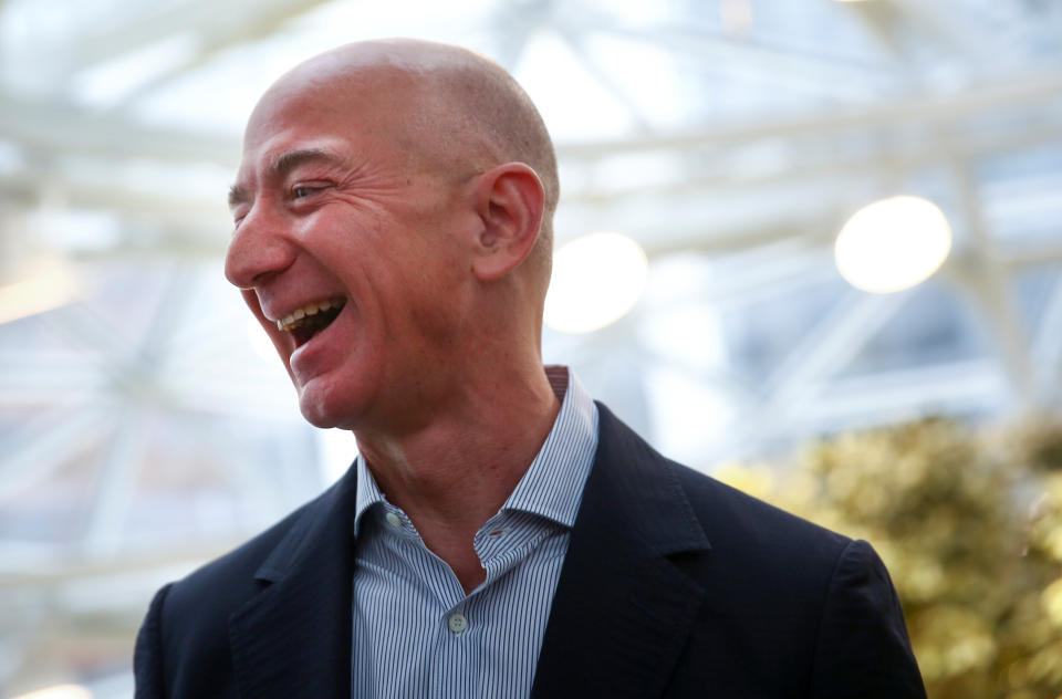 Amazon founder and CEO Jeff Bezos laughs as he talks to the media while touring the new Amazon Spheres during the grand opening at Amazon's Seattle headquarters in Seattle, Washington, U.S., January 29, 2018.   REUTERS/Lindsey Wasson