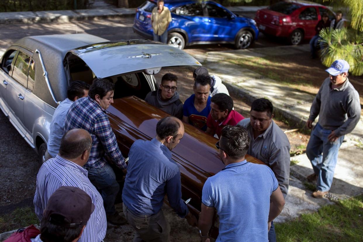 Relatives of Ocampo municipality Mayor and candidate Fernando Angeles for the Democratic Revolutionary Party (PRD) carry the coffin during his funeral in Ocampo, Michoacan State, Mexico: AFP/Getty Images