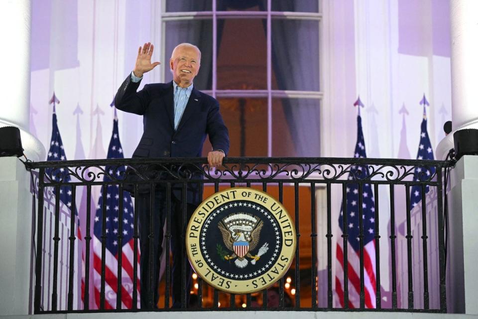 US President Joe Biden waves from the Truman Balcony of the White House (AFP via Getty Images)