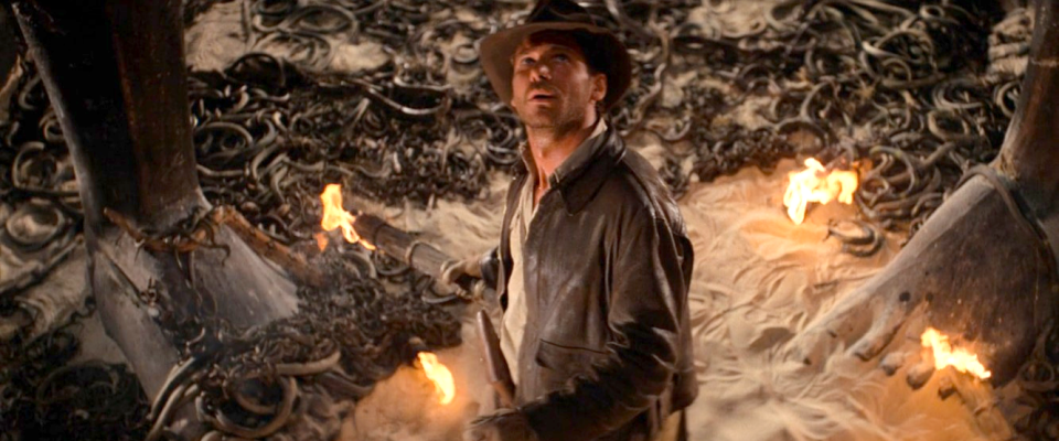 Indy holding a torch surrounded by snakes