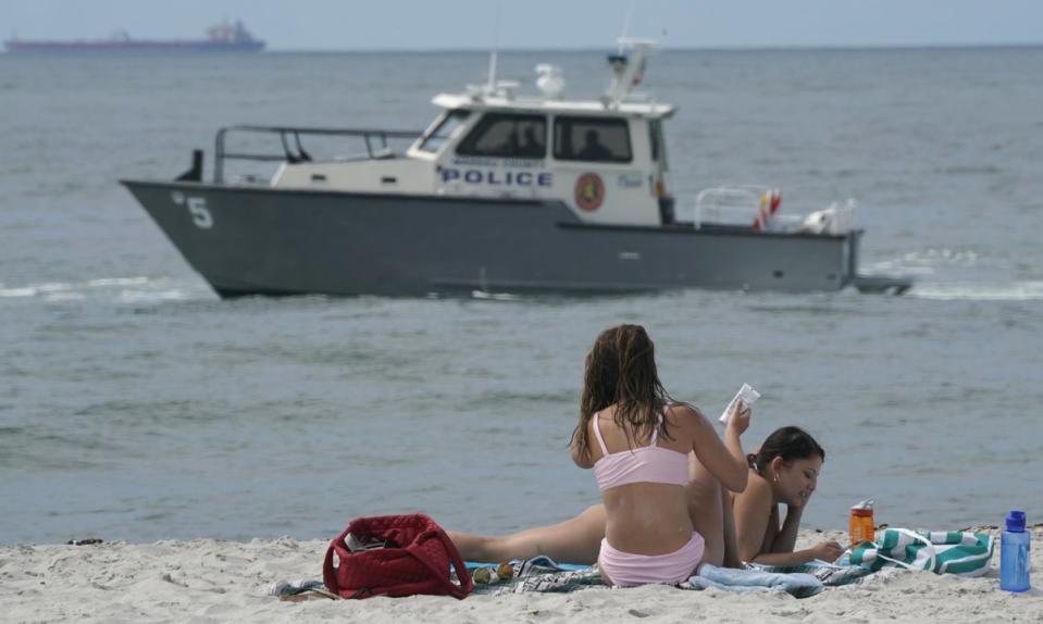 Officials have used boats, binoculars, and even drones to look out for sharks in recent years (AFP via Getty Images)