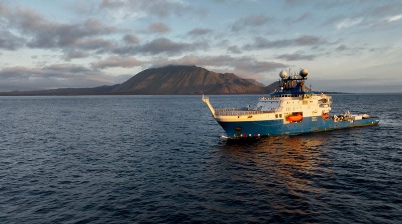 Research Vessel Falkor (too) off the Galápagos Islands during the recent expedition that discovered two pristine cold-water coral reefs.
