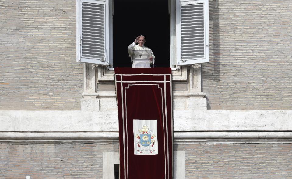 Pope Francis waves during his Angelus prayer from his studio window overlooking St. Peter's Square, at the Vatican, Sunday, Nov. 10, 2019. (AP Photo/Gregorio Borgia)