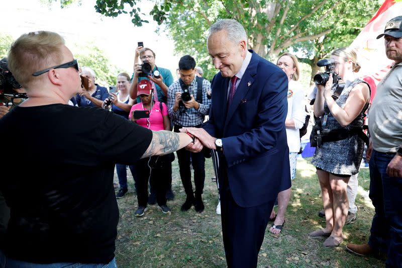 U.S. Senate Majority Leader Schumer celebrates with activists after a breakthrough to allow a vote on expanding healthcare to veterans at the U.S. Capitol in Washington