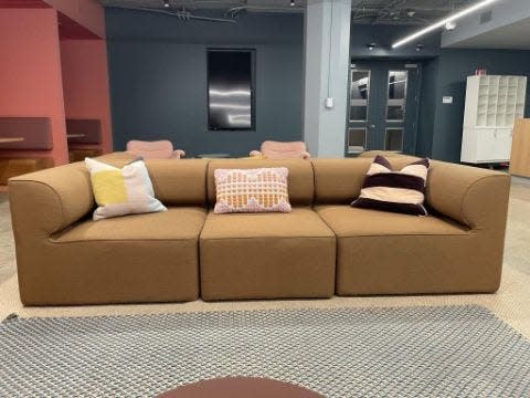 A brown couch decorated with throw pillows
