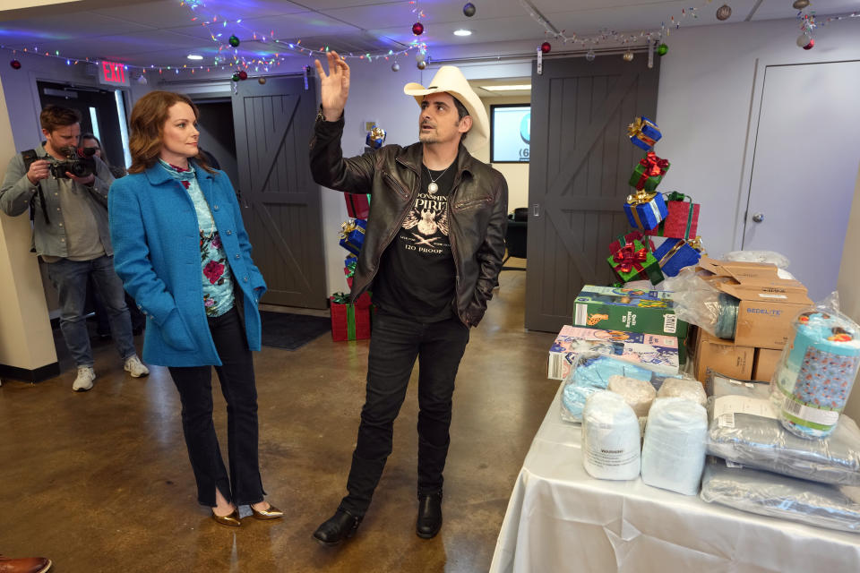 Kimberly Williams-Paisley, left, and Brad Paisley look over work that has been done at The Toy Store, a free-referral based toy store Thursday, Dec. 7, 2023, in Nashville, Tenn. The couple co-founded the facility, and they also also started The Store, a free-referral based grocery store they opened in partnership with Belmont University in March 2020. (AP Photo/Mark Humphrey)