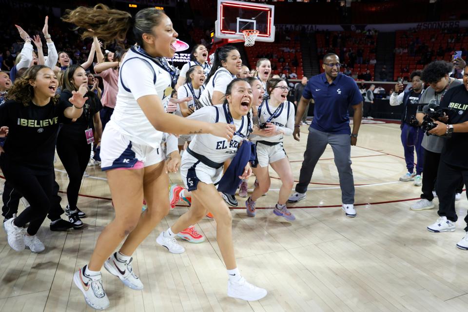 El Reno players race to collect their trophy after winning the Class 5A girls high school basketball state tournament championship game between El Reno and Sapulpa at Lloyd Noble Center in Norman, Okla., Saturday, March 9, 2024.