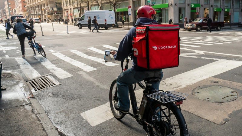 Photo of DoorDash courier on e-bike