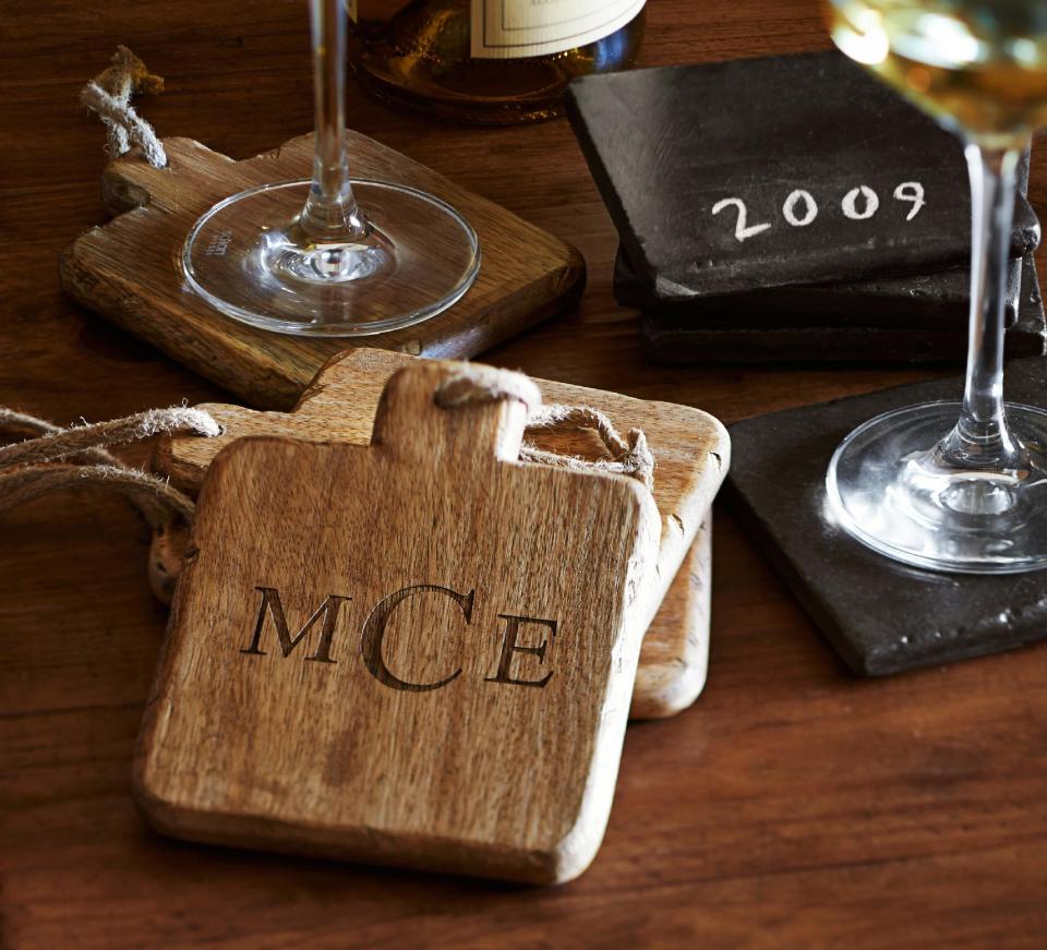 This photo provided by Pottery Barn shows wooden drink coasters that add a casual and appealing element of texture to entertaining accessories. Easier to clean than fabric coasters, they’re also useful under warm serveware at the table. (AP Photo/Pottery Barn, Alec Hemer, Joseph Antonetti)