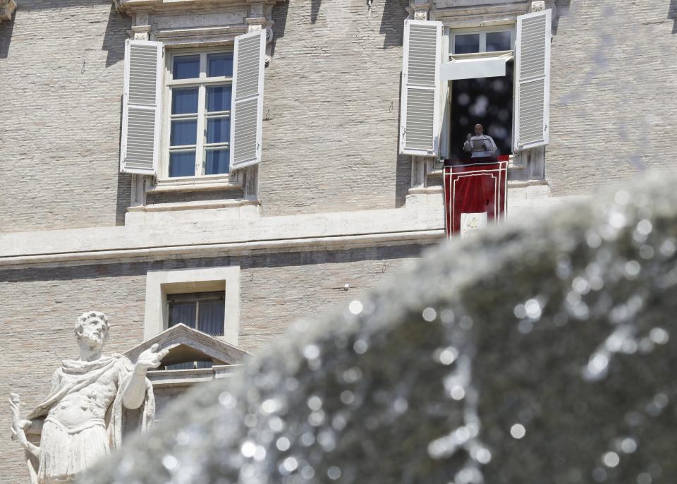 Pope Francis waves to faithful during the traditional Angelus prayer from the window of his studio overlooking St. Peter's Square, at the Vatican, Sunday, June 30, 2019. (AP Photo/Gregorio Borgia)