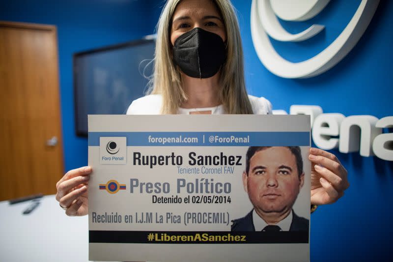 Kerling Rodriguez de Sanchez, wife of Venezuelan Air Force Lieutenant Colonel Ruperto Sanchez, who has been detained since 2014, holds a sign after a news conference by rights group Penal Forum, in Caracas