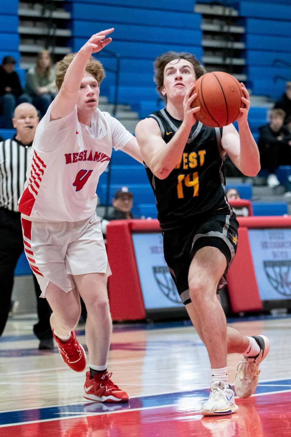 Central Bucks West's Charlie Cashman drives to the basket as Neshaminy's Ryan Meehan defends during a January 20 game.