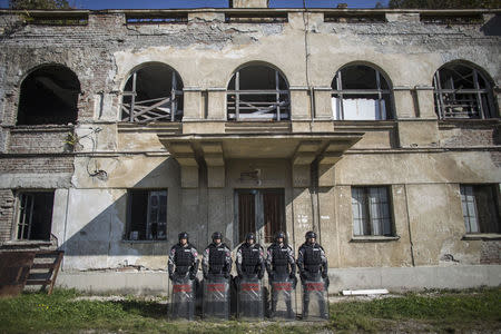 Serbian gendarmerie officers pose for a picture inside their base in Belgrade October 9, 2014. REUTERS/Marko Djurica