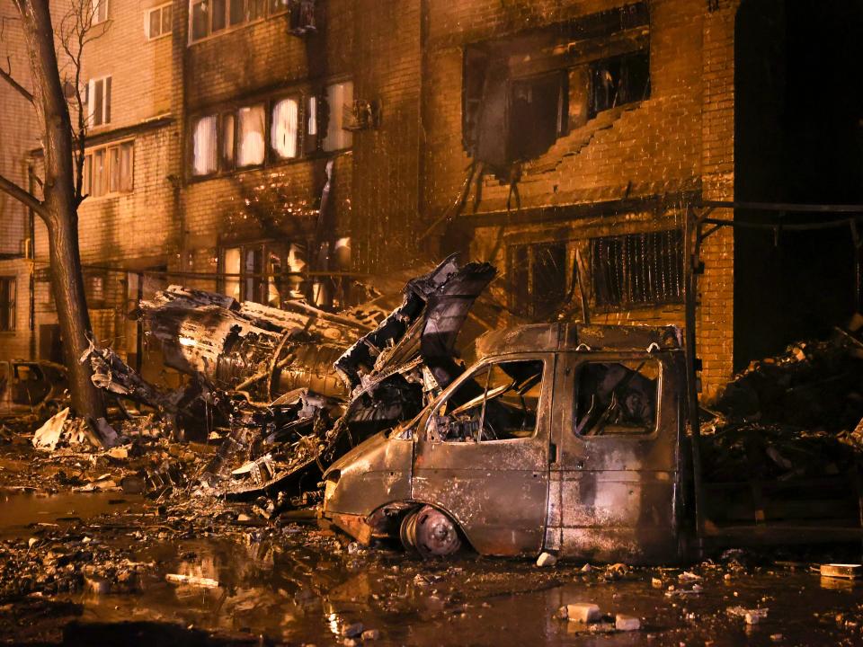 A burnt bus and debris of a warplane crashed into a residential area are seen in Yeysk, Russia, Monday, Oct. 17, 2022.