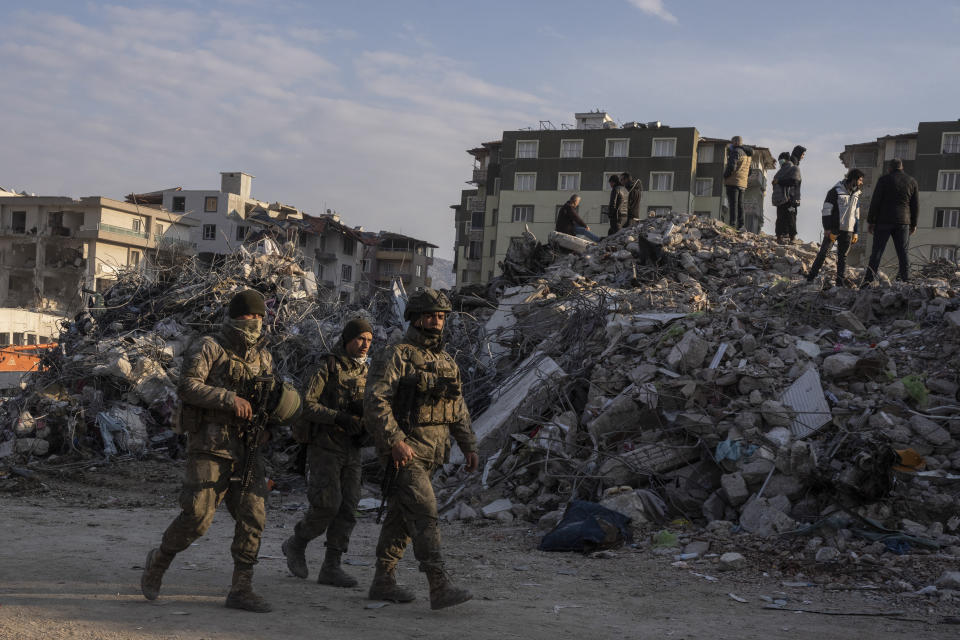 The Turkish army patrols as rescue workers continue the search for victims of the earthquake in Antakya, Turkey, Saturday, Feb. 11, 2023. Rescue crews on Saturday pulled more survivors, including entire families, from toppled buildings despite diminishing hopes as the death toll of the enormous quake that struck a border region of Turkey and Syria five days continued to rise. (AP Photo/Petros Giannakouris)