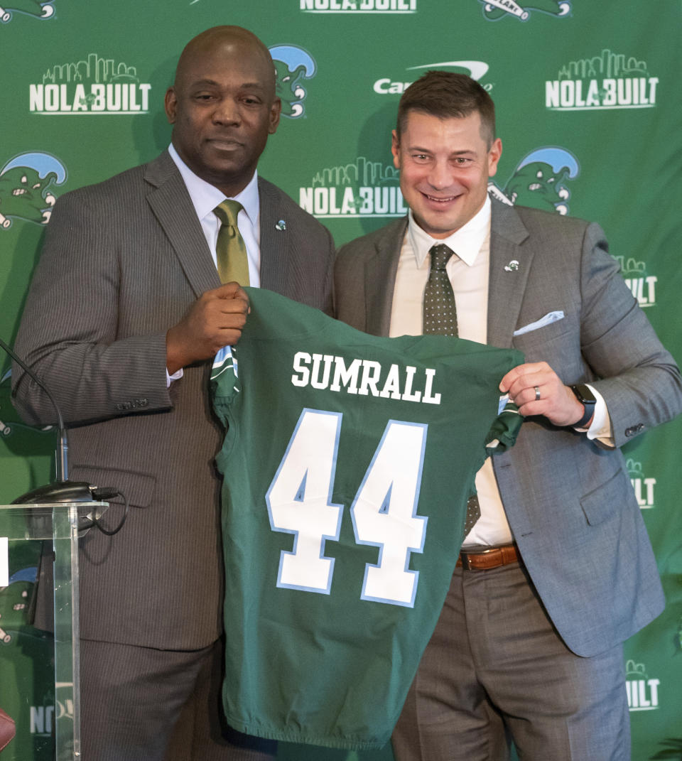Jon Sumrall, right, the new head NCAA college football coach at Tulane, is introduced by athletic director David Harris, left, during a ceremony at Yulman Stadium in New Orleans, Monday, Dec. 11, 2023. (David Grunfeld/The Times-Picayune/The New Orleans Advocate via AP)