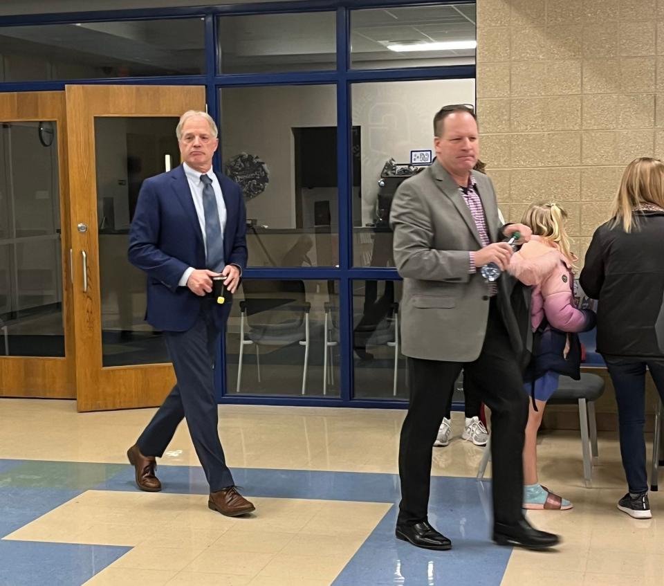 Chris Long (right), former middle and high school principal of Garretson High School and head football coach, walks between the administrative office at the Garretson school and the library with his attorney, David Kroon, on Feb. 24, 2022.