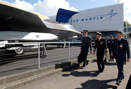 FILE PHOTO: A Danish delegation walks pass Lockheed Martin's F-35 Lightning II, at the Farnborough Airshow in southern England, July 11, 2012. REUTERS/Luke MacGregor/File Photo