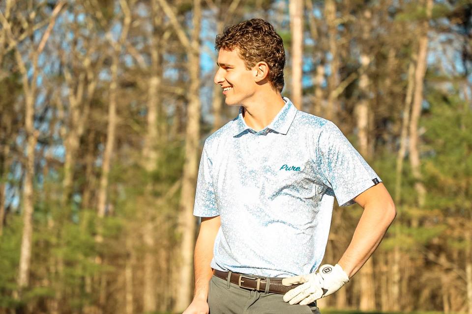 Ian Fowler, who created Pure Golf Apparel with his youngest brother, Will, wears a T-shirt from his golf clothing company.