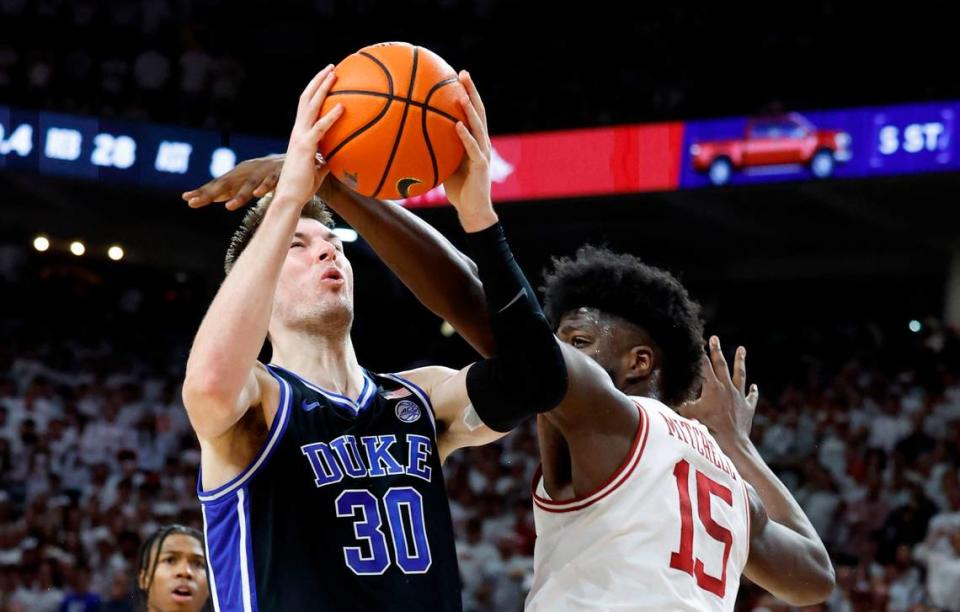 Duke’s Kyle Filipowski (30) shoots while defended by Arkansas’ Makhi Mitchell (15) during the second half of Arkansas’ 80-75 victory over Duke at Bud Walton Arena in Fayetteville, Ark., Weds. Nov. 29, 2023.