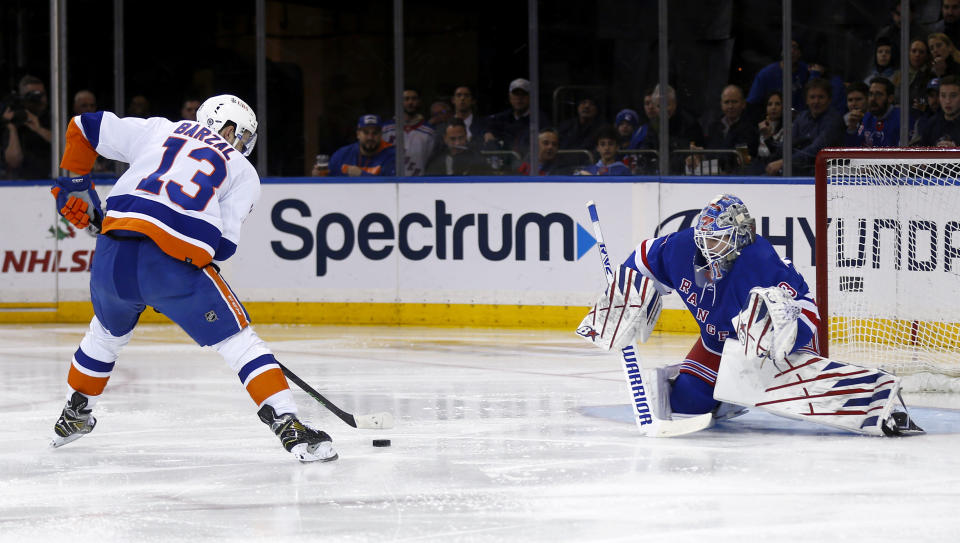 New York Islanders center Mathew Barzal (13) scores past New York Rangers goalie Igor Shesterkin during the second period of an NHL hockey game Thursday, Dec. 22, 2022, in New York. (AP Photo/John Munson)