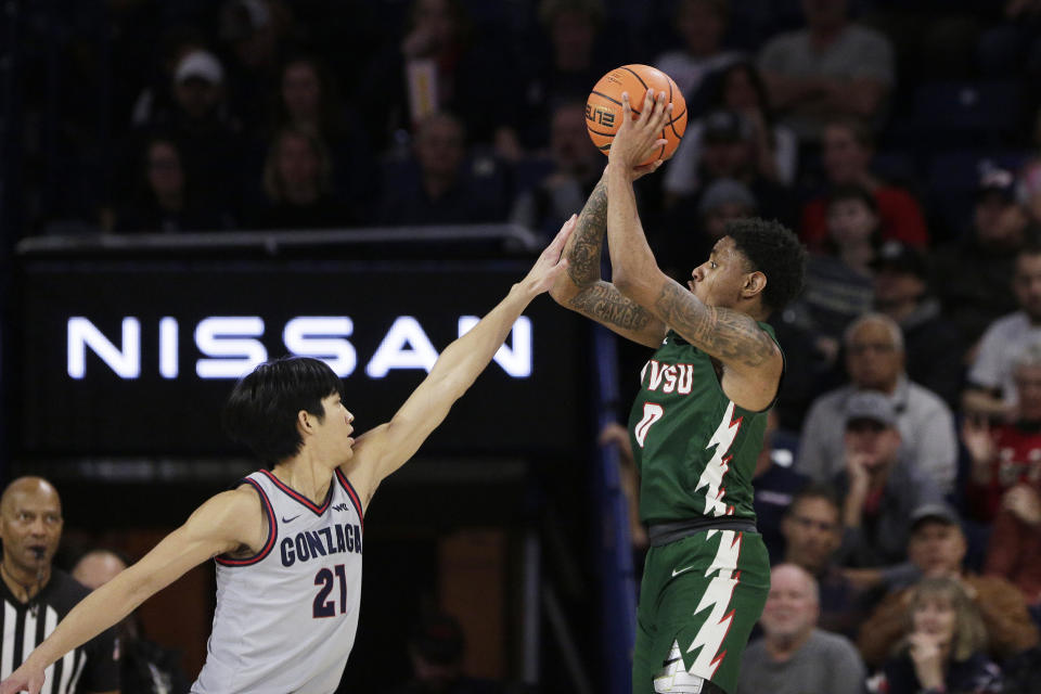 Mississippi Valley State guard Rayquan Brown (0) shoots while pressured by Gonzaga forward Jun Seok Yeo (21) during the first half of an NCAA college basketball game, Monday, Dec. 11, 2023, in Spokane, Wash. (AP Photo/Young Kwak)