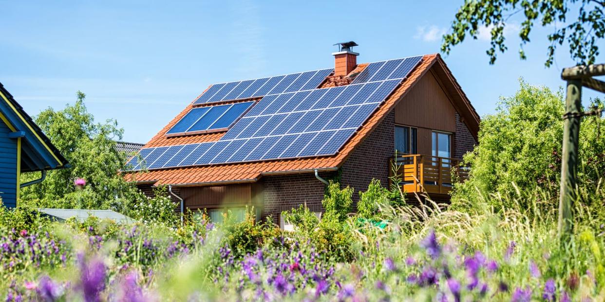 house with solar panels in summertime